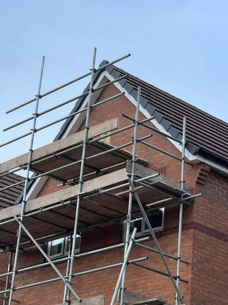 This is a photo of a roof which has just been repaired. There is a scaffold located at the gable end for access onto the roof. Works carried out by Fulbourn Roofing Repairs